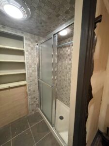 Bathroom remodel contractor in Fox Chapel, Pittsburgh installing modern fixtures, tiles, and a new vanity in a stylish renovation