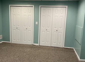 Klein Contracting General Contractor, utilizes a Basement remodeling contractor in Pittsburgh installing drywall and lighting in a modern finished basement renovation project.